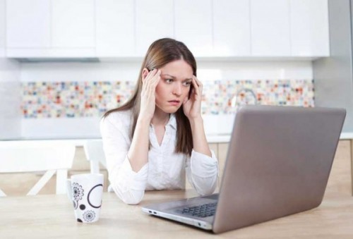 Frustrated woman sitting at a laptop